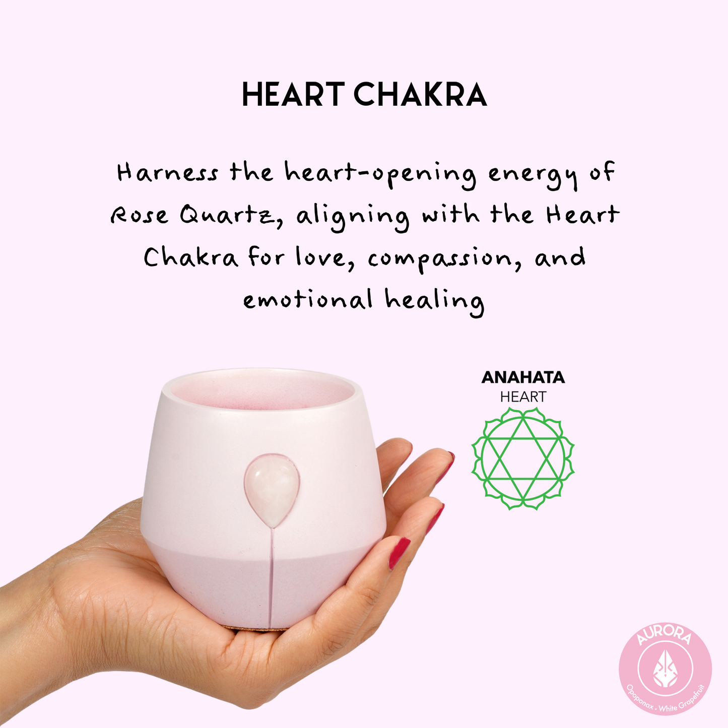Image of Luna Aurora candle in a hand with the aligned chakra symbol and text that reads: Harness the heart opening energy Rose quartz, aligning with the heart chakra for love, compassion and emotional healing. 