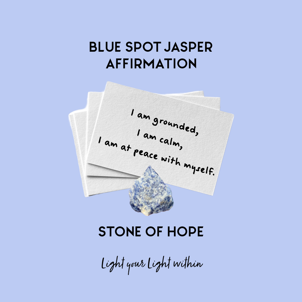 Image of Blue Spot Jasper Affirmation Cards held together with a Blue Spot Jasper crystal the affirmation reads:I am grounded, I am calm, I am at peace with myself. 